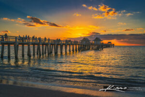 The Naples Pier reaching into the Gulf at sunset